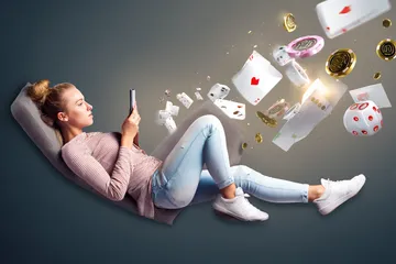 GOOD111 Mobile Casino — Play anytime, anywhere A player using their smartphone during a festive local event, representing GOOD111’s fully mobile-friendly casino.